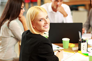 http://www.dreamstime.com/royalty-free-stock-photos-portrait-smiling-businesswoman-office-her-colleagues-background-image41681008